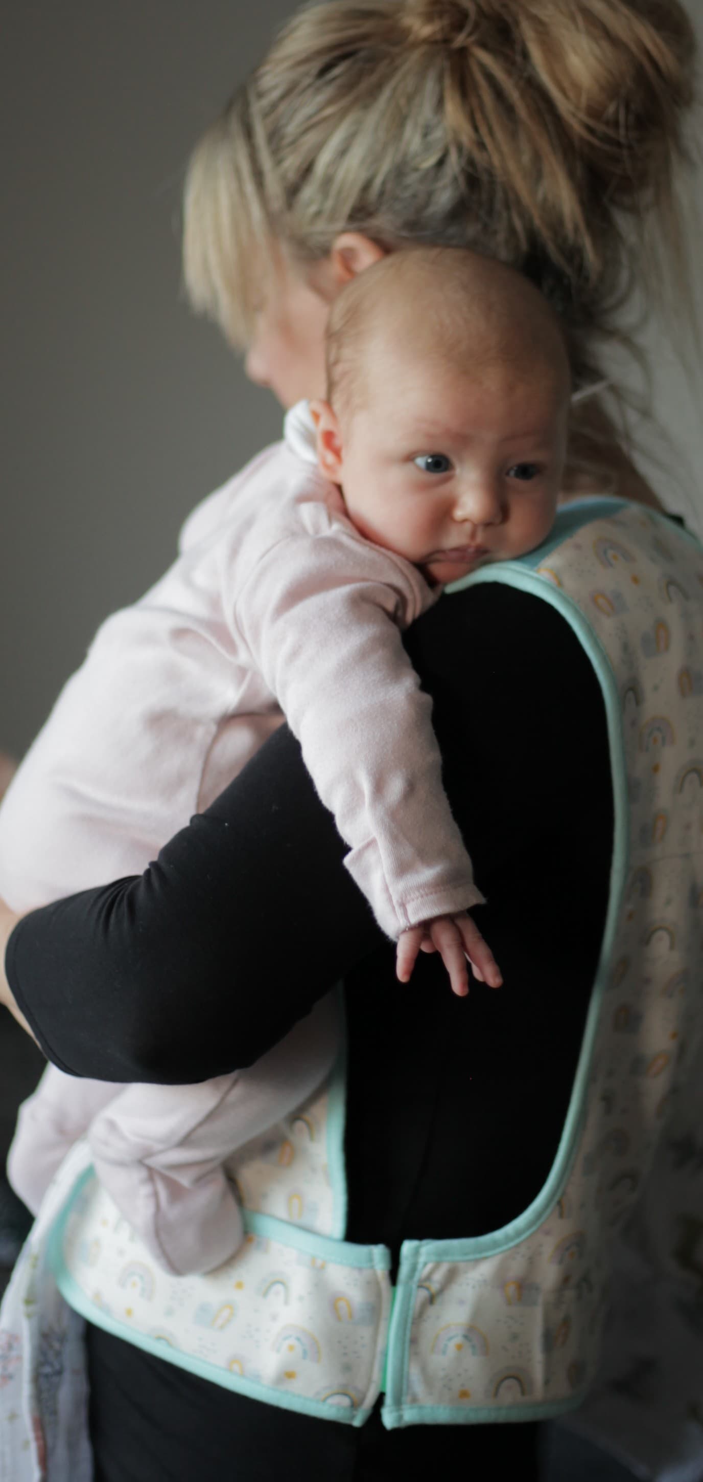 Mother wearing Cool Cuddle while holding baby